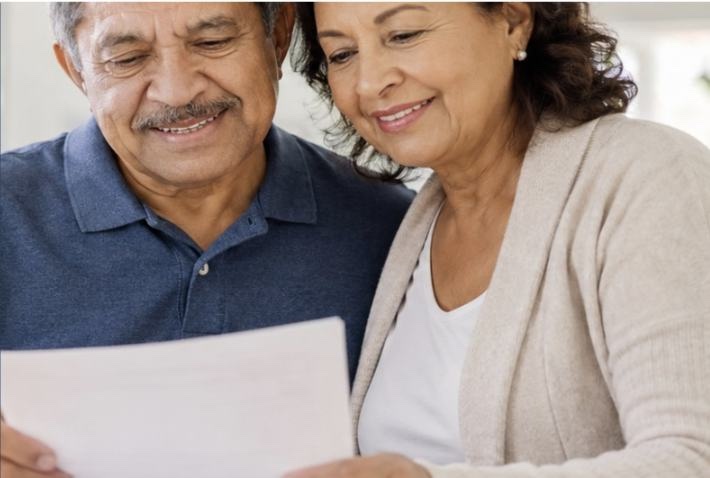 A couple reading through their health plan paperwork together